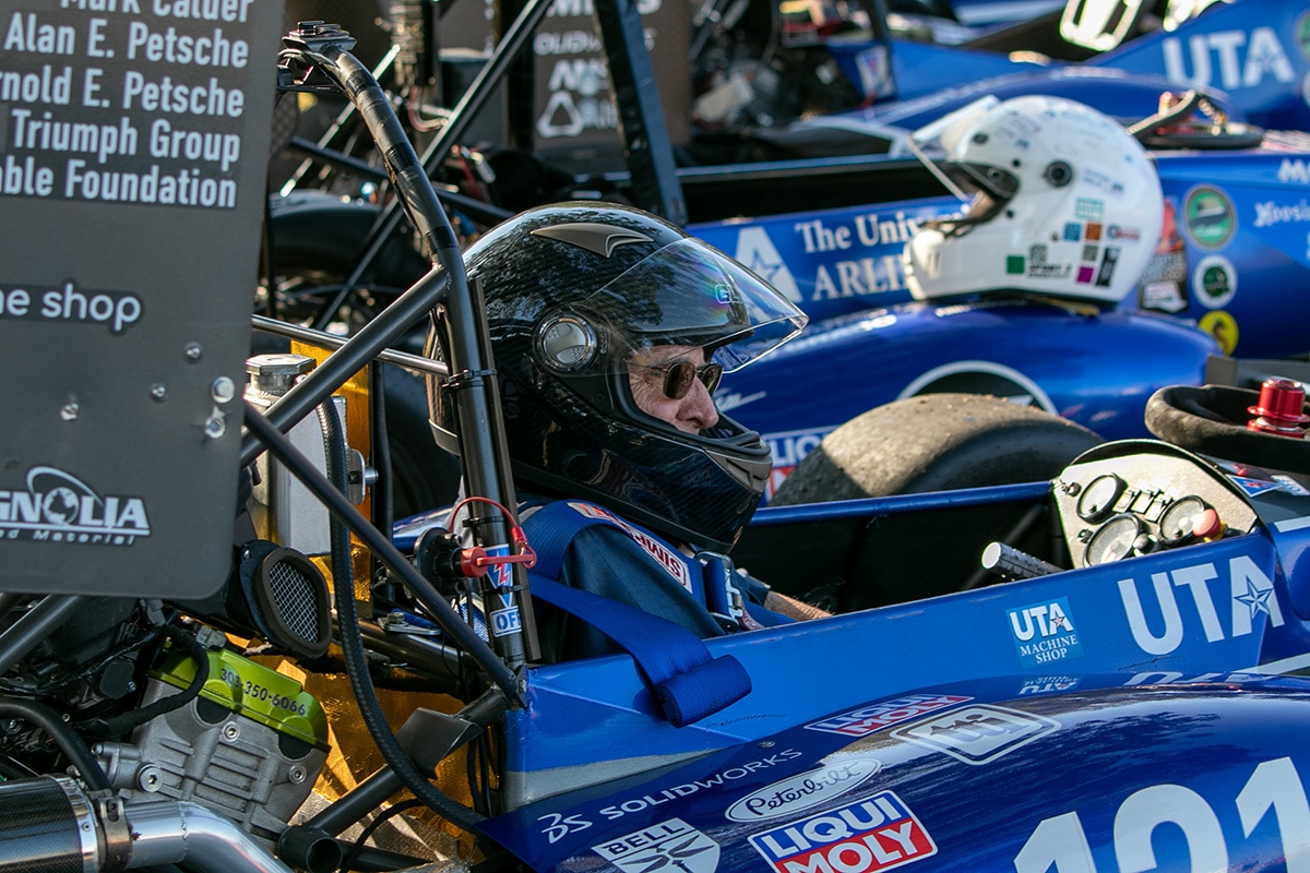 Man sitting in a UTA racecar - opens in a new tab