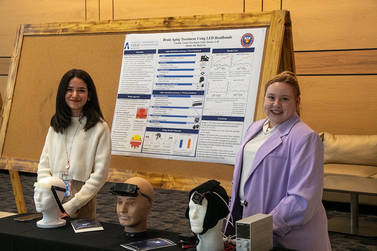 Two women standing next to models of their project at a UTA event - opens in a new tab
